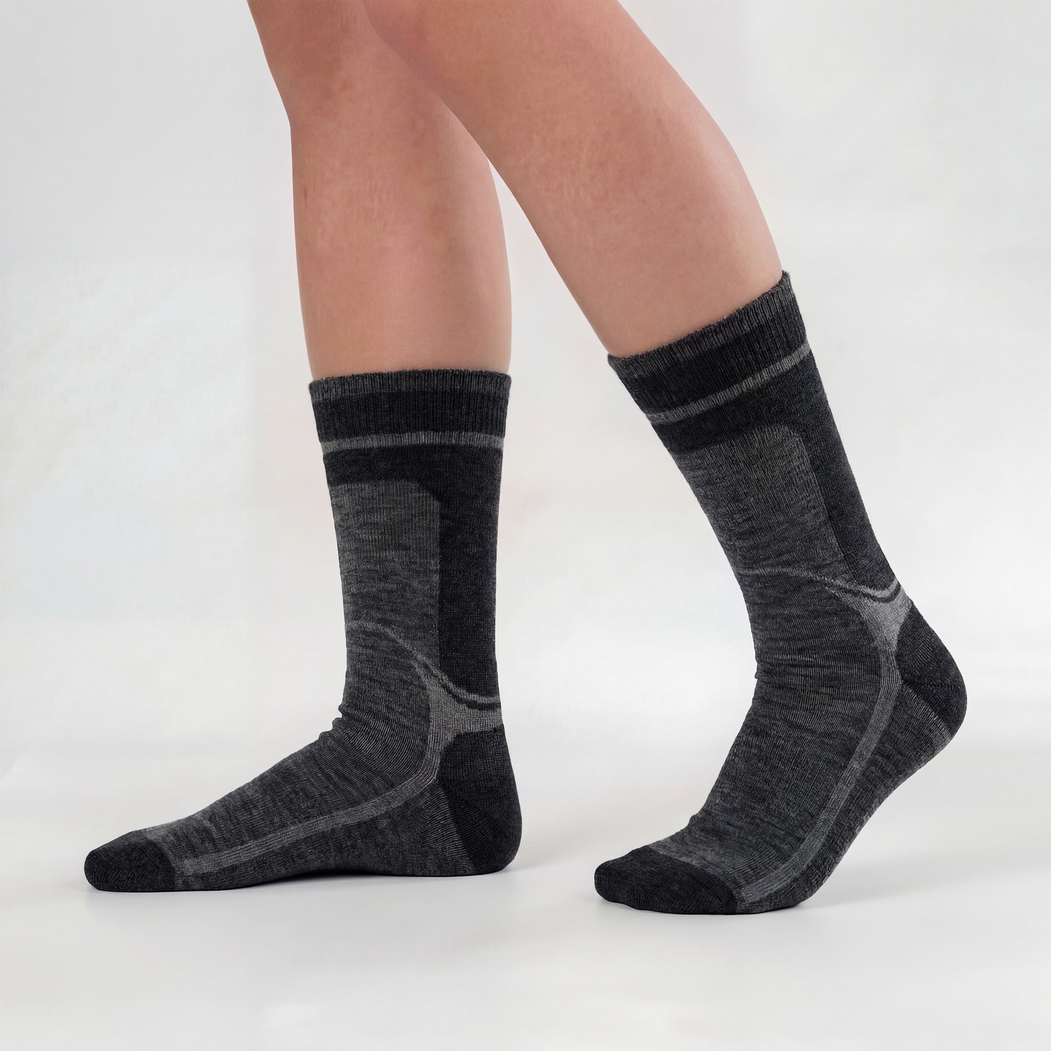 A person wearing grey Socks wool - Janusull stands on a white background, one foot flat and the other slightly raised.