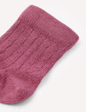A close-up of the top portion of the Socks – Merino Baby Light in textured, ribbed purple wool, shown against a plain white background.