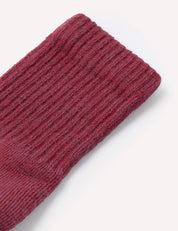A close-up of the Terry Socks – Merino Kids in maroon, highlighting the ribbed texture and plush thickness of the wool terry fabric against a white background.