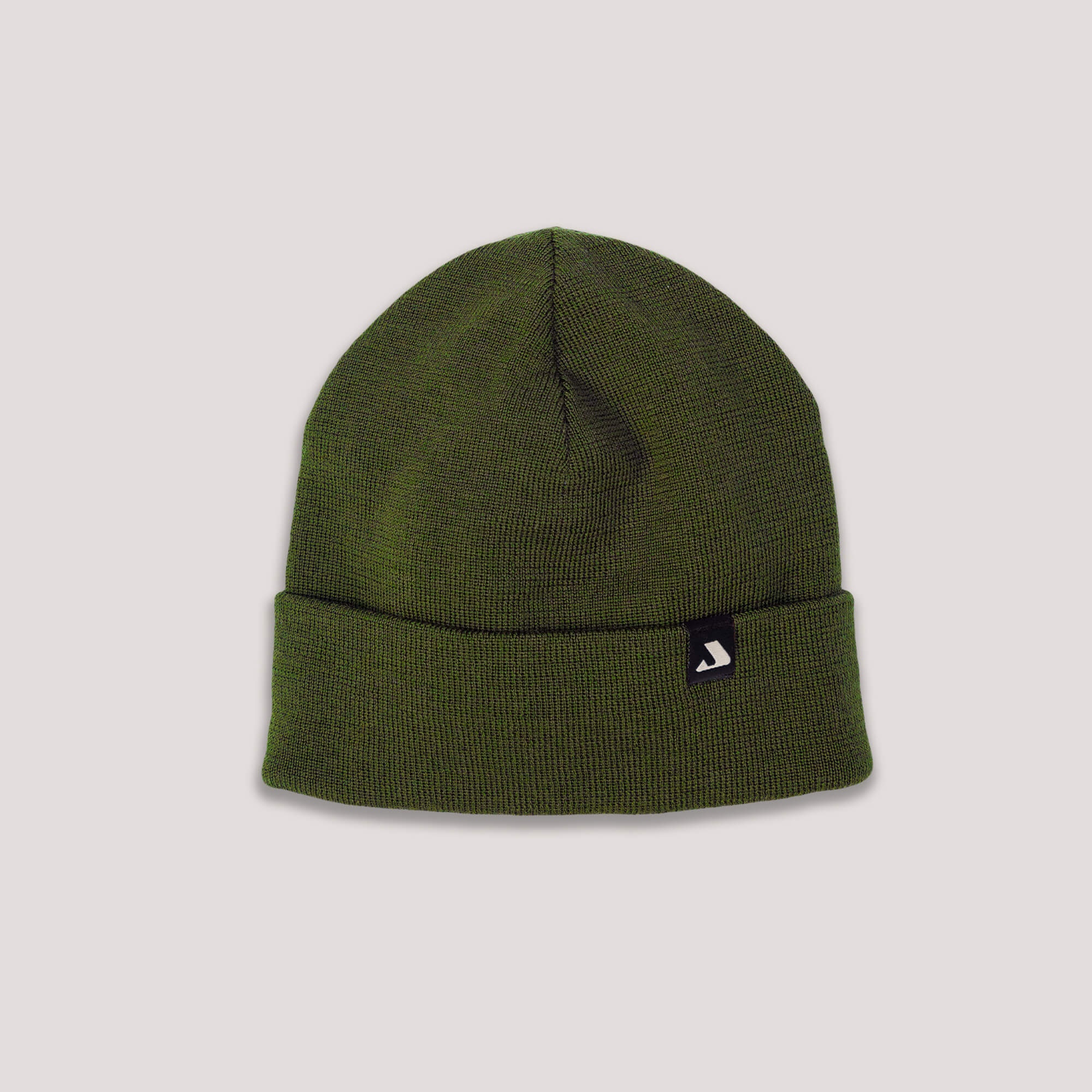The Beanie – MeshWool in Forest Night is a warm merino wool hat with a folded brim and a small black patch with a white logo on the front, shown on a plain light background.