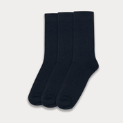 Three pairs of black socks on a light gray background