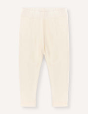 Marshmallow-colored Merino Baby Light leggings for babies or toddlers, featuring a lightweight fabric and an elastic waistband. Displayed flat on a plain light background, these leggings have a simple, minimalist design with no visible patterns or embellishments.