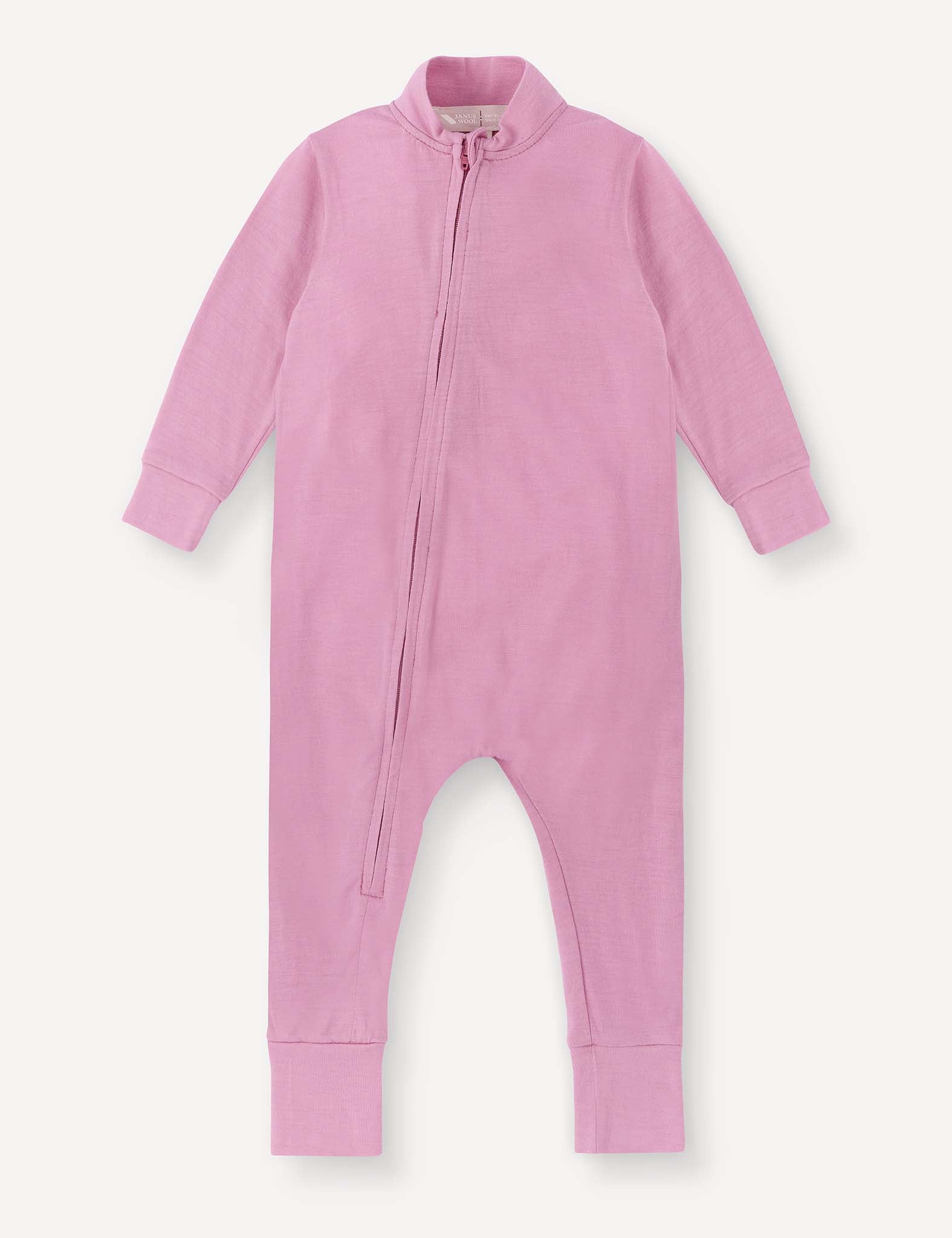 A long-sleeve mauve orchid “Pyjamas – Merino Baby Light” onesie featuring a soft, breathable fabric and ribbed cuffs, with a diagonal zipper running from the neck to the left leg.