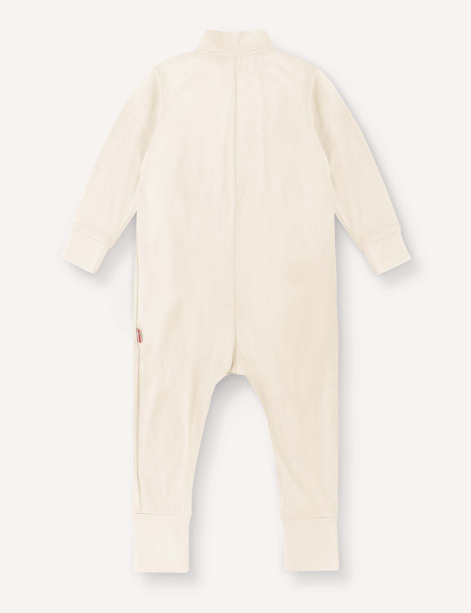 A cream-colored, long-sleeve Pyjamas – Merino Baby Light onesie with closed feet and cuffs is shown flat from the back on a plain white background. Crafted from breathable, moisture-managing pyjamas fabric to ensure your baby’s comfort.