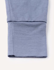 A close-up of the blue cuff from the Pyjamas – Merino Baby Light, showcasing detailed stitching and a neatly folded hem characteristic of these breathable pyjamas.