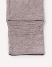 Close-up of a folded sleeve from the Pyjamas – Merino Baby Light, crafted in light brown, heathered merino wool and displayed on a plain white background—an ideal detail for those seeking breathable sleepwear.
