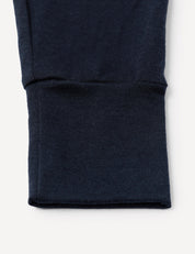 Close-up of a navy blue ribbed cuff on a sleeve, part of the Pyjamas – Merino Baby Light, against a white background.