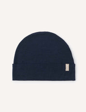 A lightweight Navy “Beanie – Merino Baby Light” with a subtle folded brim and a small beige fabric tag on the right side, displayed on a light background.