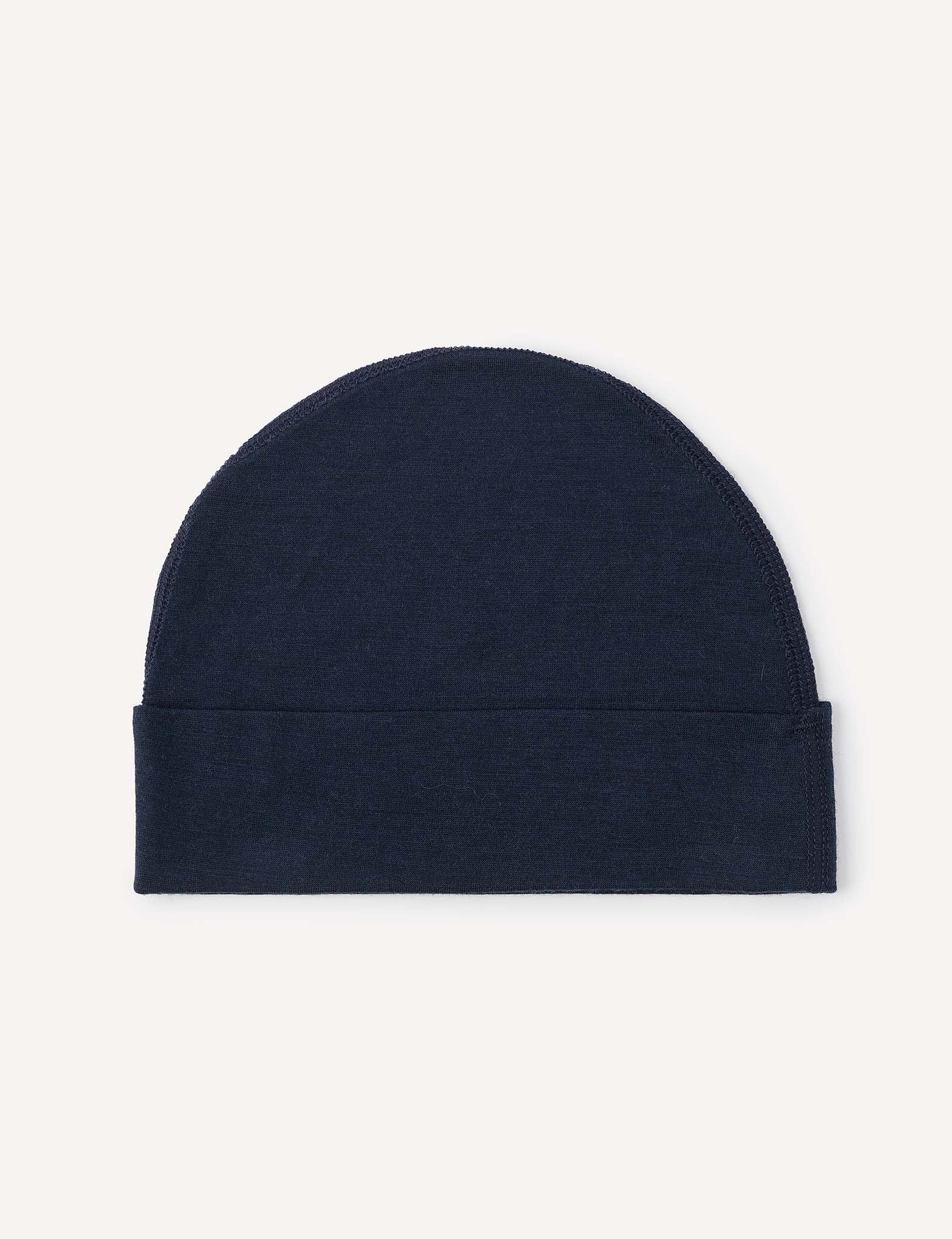 A Beanie – Merino Baby Light in plain dark blue, featuring a lightweight design and folded bottom, displayed flat against a light background.