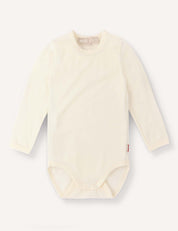 A long-sleeve, marshmallow-colored “Body – Merino Baby Light” bodysuit made from breathable merino wool, featuring snap closures at the bottom and displayed flat on a light background. This soft baby clothing provides both comfort and style for your little one.