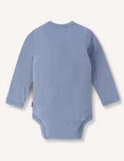 The Body – Merino Baby Light in light blue, featuring long sleeves, is displayed from the back and laid flat on a plain white background.