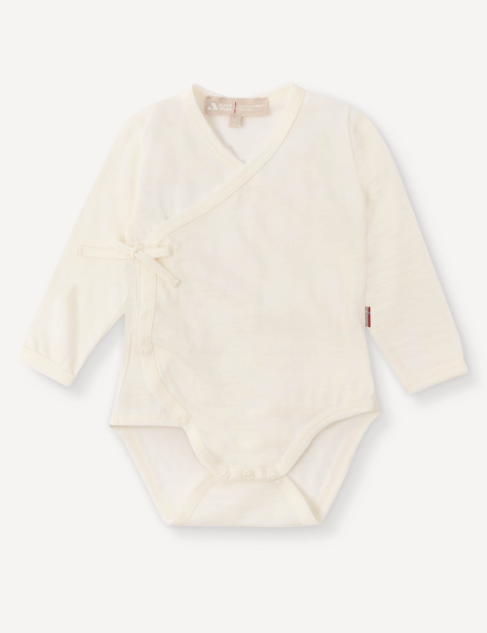 Wrapover Bodysuit – Merino Baby Light in Marshmallow, featuring long sleeves, a side tie, and snap buttons at the bottom, laid flat on a white background.