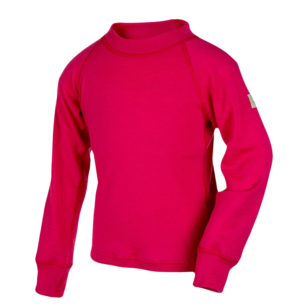 The Jersey Merino – Janusull 200 Kids is a bright pink children's long-sleeve merino wool shirt with a high collar, visible seams, and a small white tag on the left sleeve, shown against a white background.