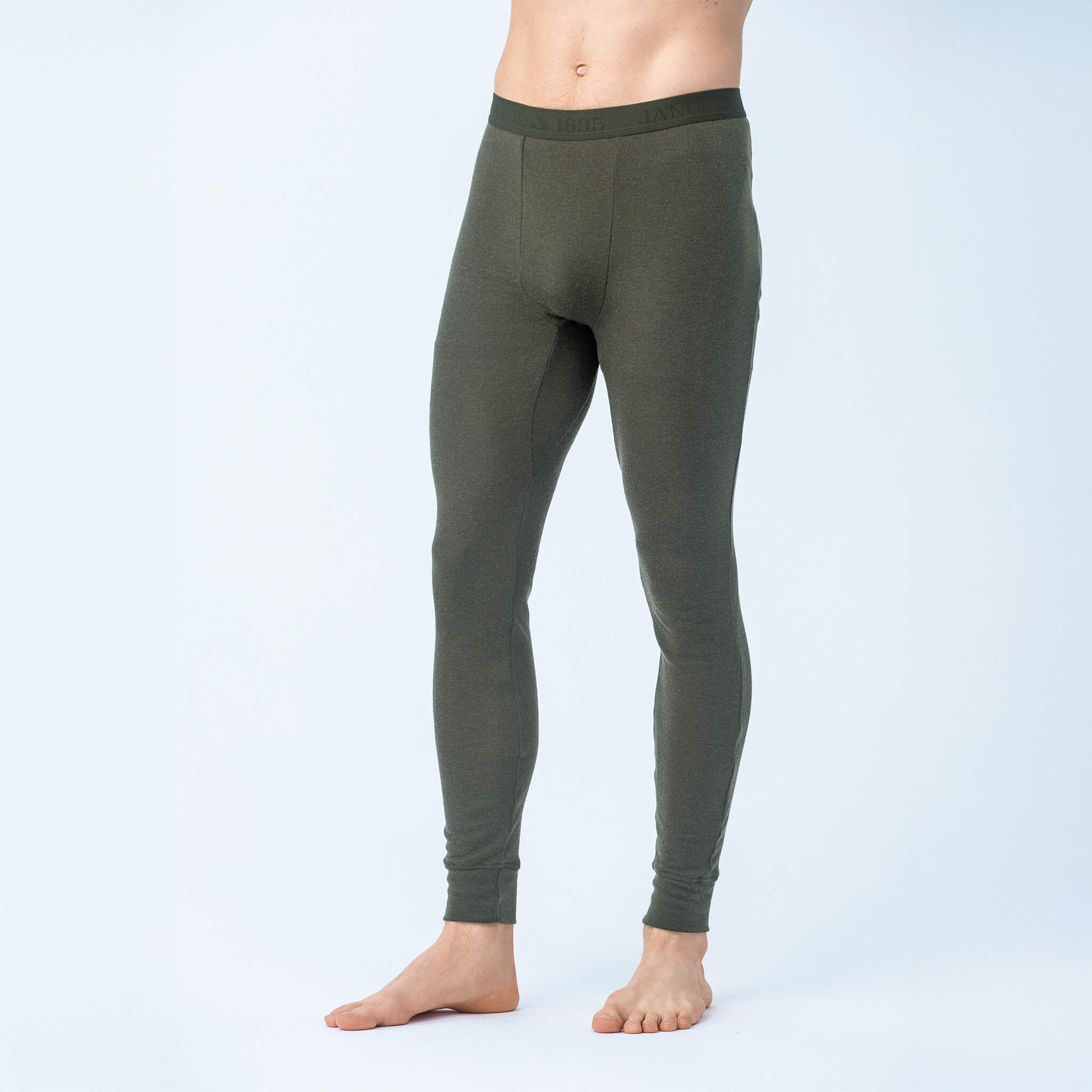 A person models the Leggings – Classic Merino 215 Men in Forest Night, standing barefoot against a plain light background, shown from chest to feet.
