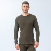 Man wearing Janus Wool Classic Merino green long-sleeve shirt on a light gray background