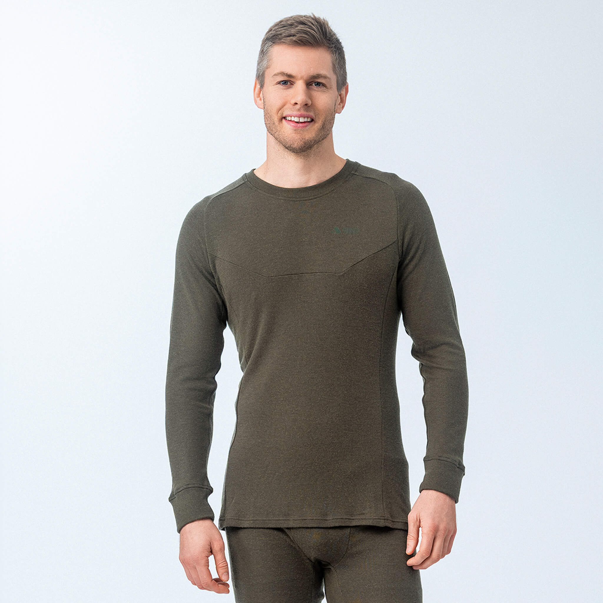 Man wearing Janus Wool Classic Merino green long-sleeve shirt on a light gray background