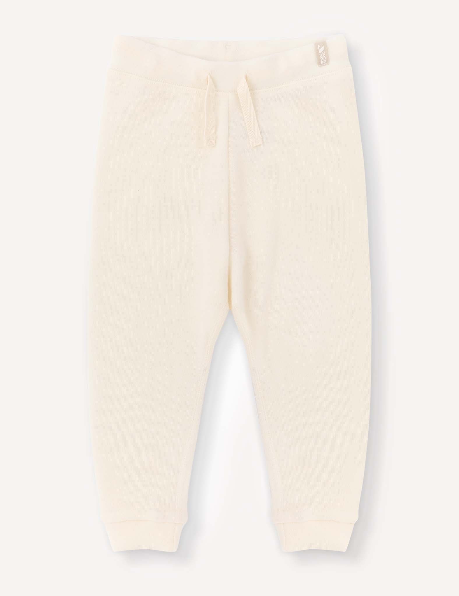 Marshmallow-colored Pants – Merino Baby AirWool with a relaxed fit, featuring a drawstring waistband and ribbed cuffs, laid flat on a plain light background.