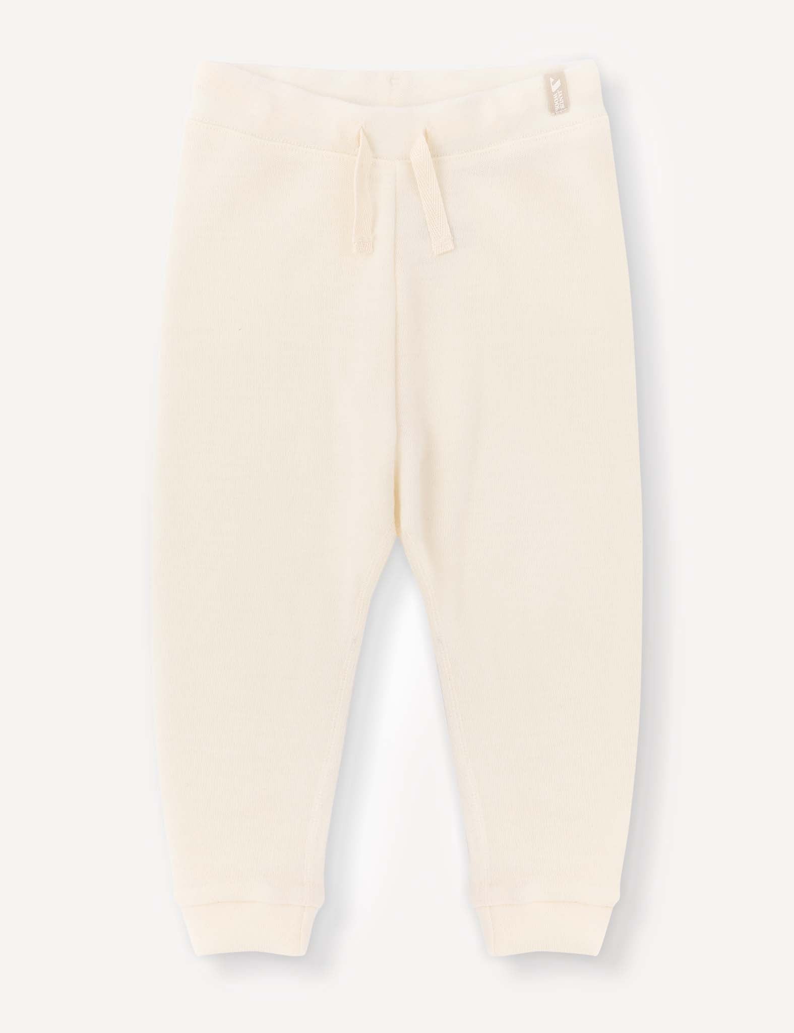 Marshmallow-colored Pants – Merino Baby AirWool with a relaxed fit, featuring a drawstring waistband and ribbed cuffs, laid flat on a plain light background.