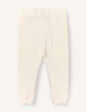 Cream-colored Merino Baby AirWool pants for babies or toddlers, featuring an elastic waistband and cuffed ankles, laid flat on a light background and displayed from the back for a relaxed fit.