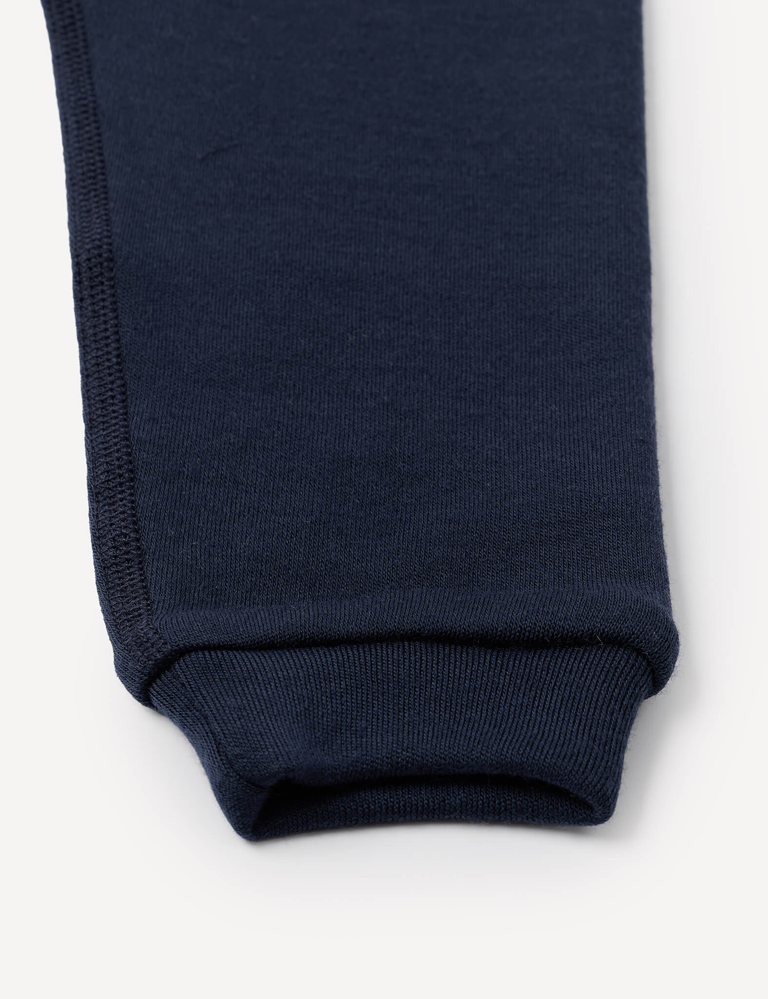 Close-up of the cuff of the Pants – Merino Baby AirWool in navy blue, highlighting the hem and stitching detail against a plain white background.