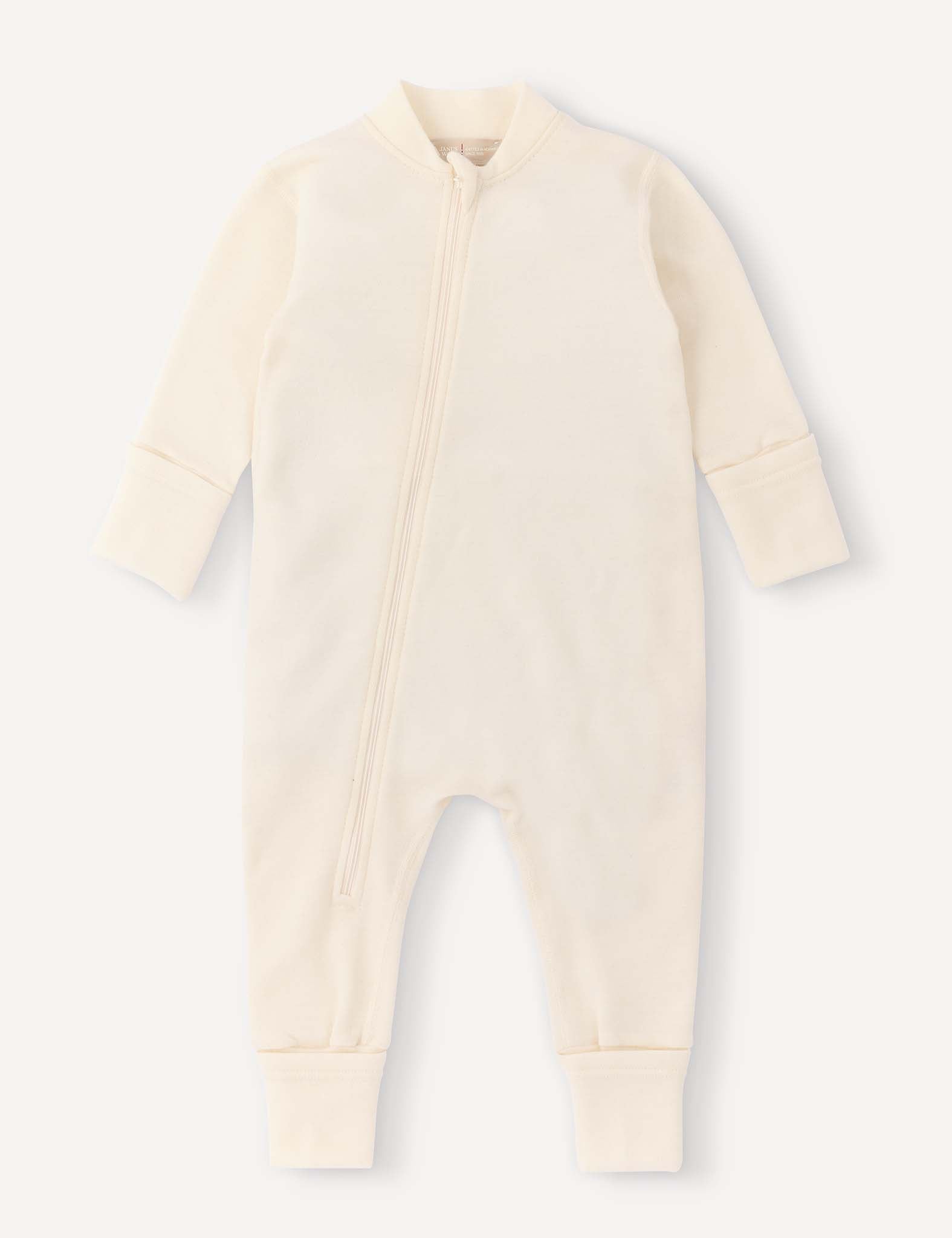 Marshmallow-colored Onesie – Merino Baby AirWool featuring long sleeves, long legs, fold-over cuffs, and a diagonal front zipper. The garment is laid flat on a plain light background, with no visible patterns or decorations. The breathable merino wool insulation ensures comfort for your little one.