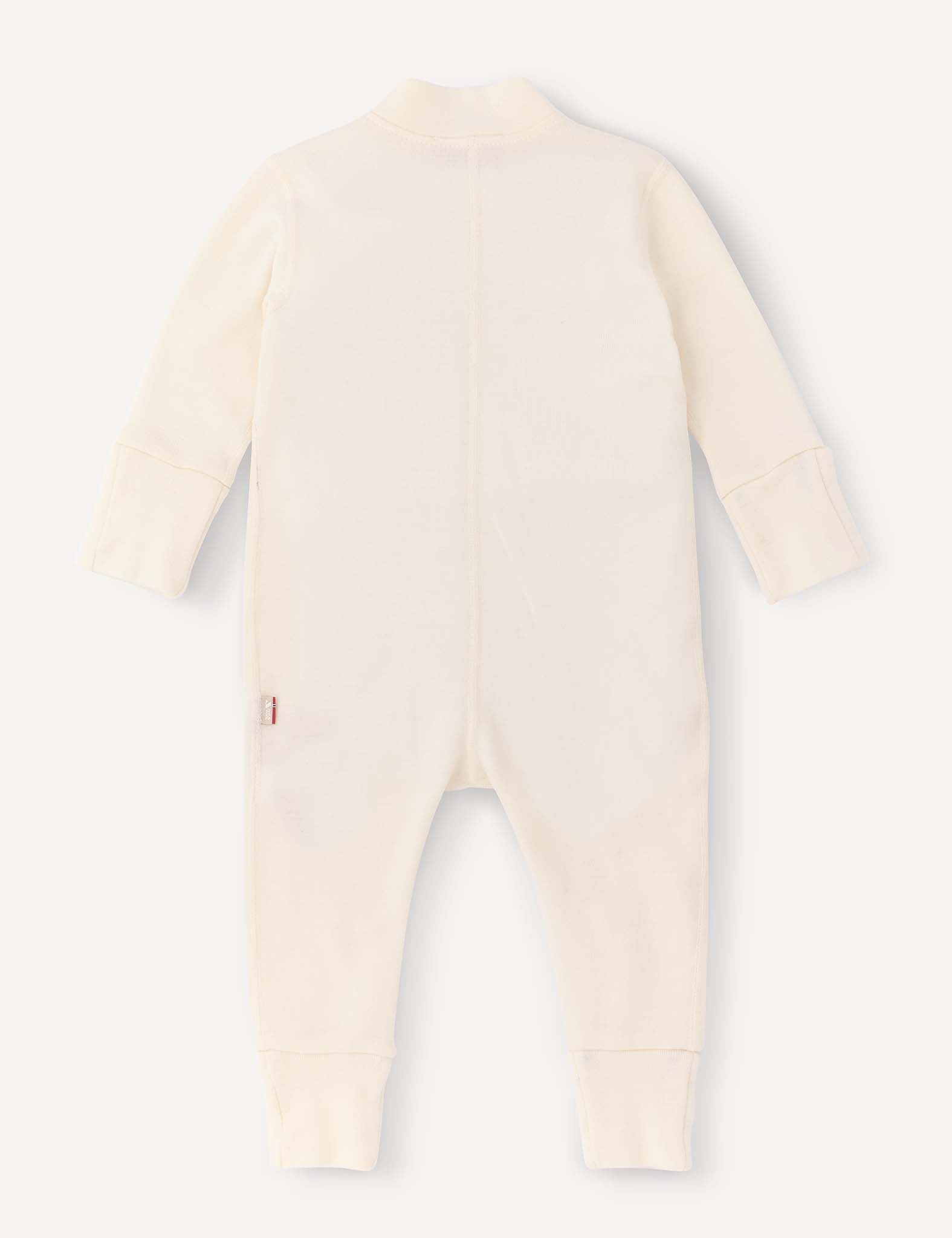A long-sleeve, cream-colored Onesie – Merino Baby AirWool made from breathable insulation is shown laid flat with the back facing up. The onesie features fold-over cuffs at the wrists and ankles, as well as a small side tag.