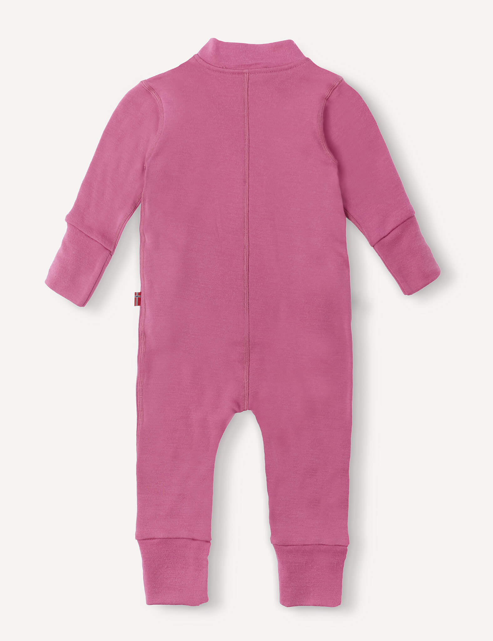 A footless, long-sleeve pink Onesie – Merino Baby AirWool is laid flat with the back side facing up, highlighting a visible center seam and ribbed cuffs at the wrists and ankles.