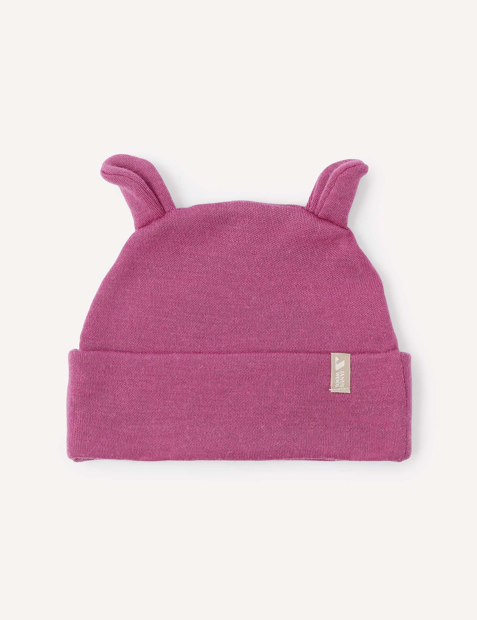 A Hawthorn Rose Beanie – Merino Baby AirWool featuring two small, pointy ear-like flaps on top and a folded brim with a petite fabric tag. Crafted for breathable insulation, it ensures cozy comfort for little ones.