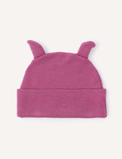 A Beanie – Merino Baby AirWool in pink, featuring two small pointed ear-like shapes on top, is laid flat on a light background. Crafted from merino wool, this baby beanie provides breathable insulation for comfort.