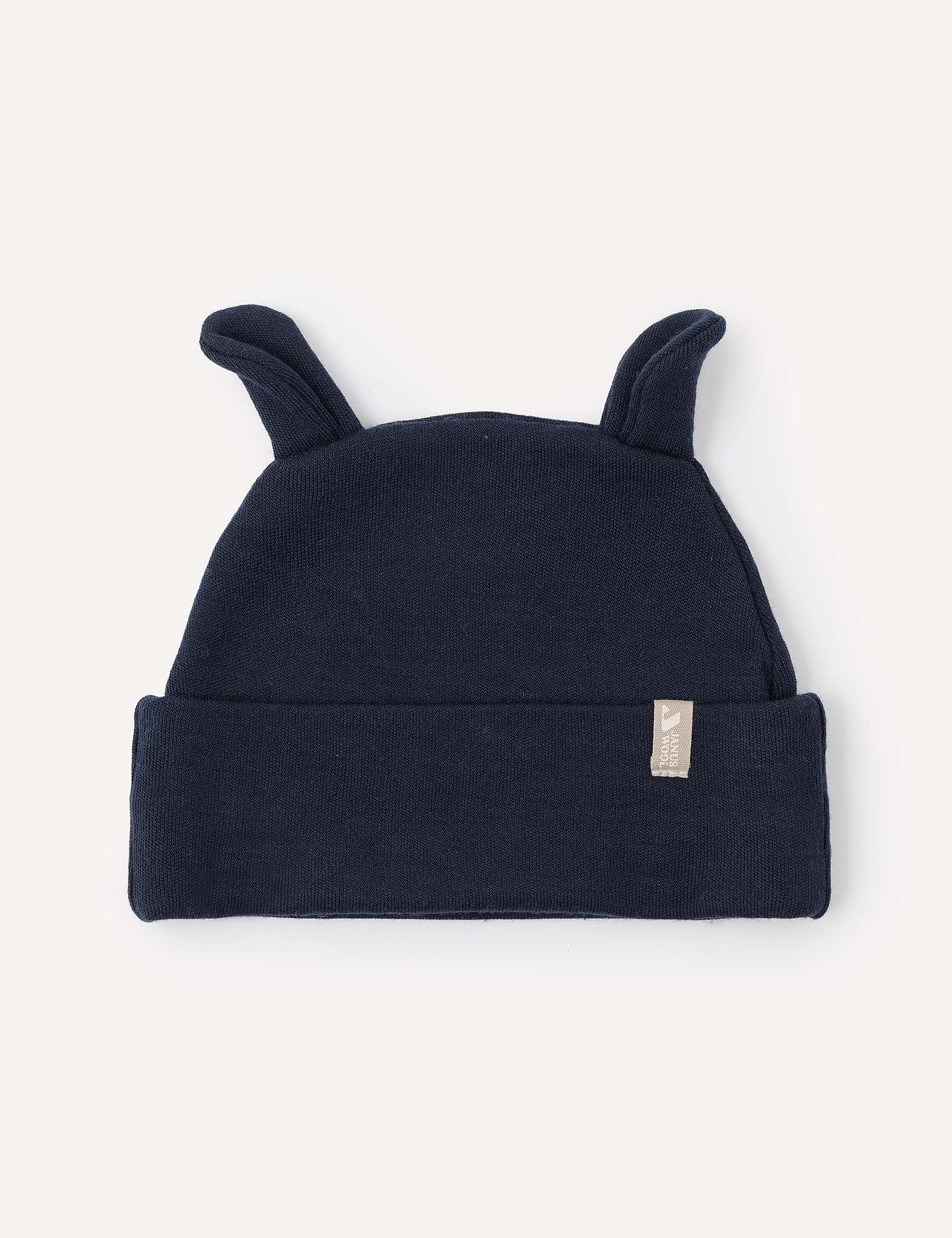 The Beanie – Merino Baby AirWool in Navy is a cozy merino wool baby hat featuring two small fabric ears on top and a folded brim. Shown against a light background, this warm beanie provides breathable insulation for your little one.