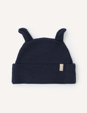 The Beanie – Merino Baby AirWool in Navy is a cozy merino wool baby hat featuring two small fabric ears on top and a folded brim. Shown against a light background, this warm beanie provides breathable insulation for your little one.