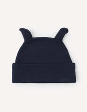 The Beanie – Merino Baby AirWool is a dark blue knit baby beanie with two small, pointy fabric ears on top, made from breathable merino wool and displayed against a plain light background.