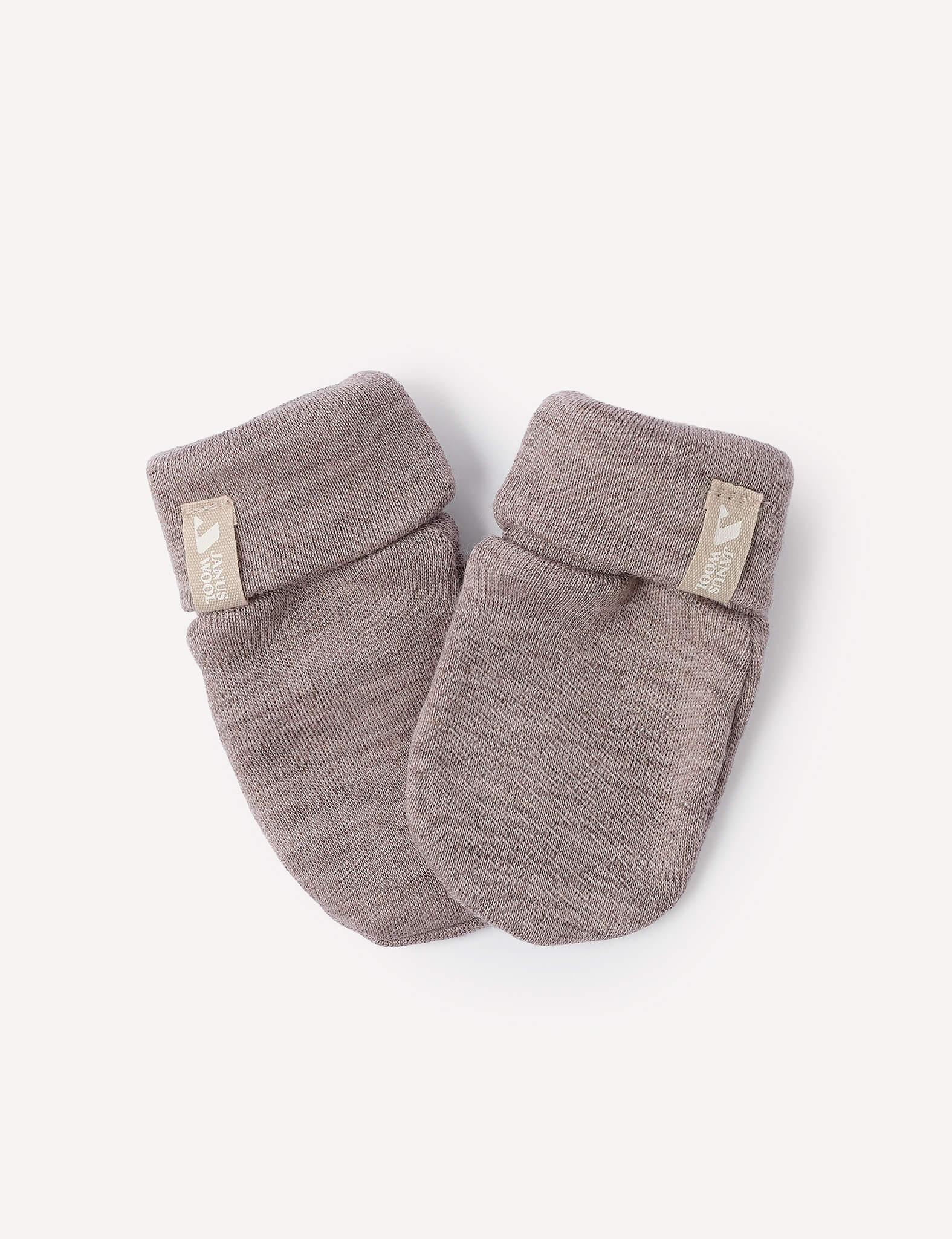 A pair of Mittens – Merino Baby AirWool in soft, light brown merino wool with folded cuffs and a small fabric label on each cuff, displayed on a plain white background.