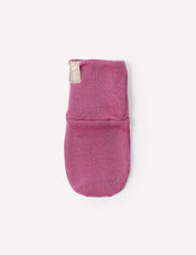 A single Mittens – Merino Baby AirWool in pink, featuring a small beige tag, is displayed on a plain white background.