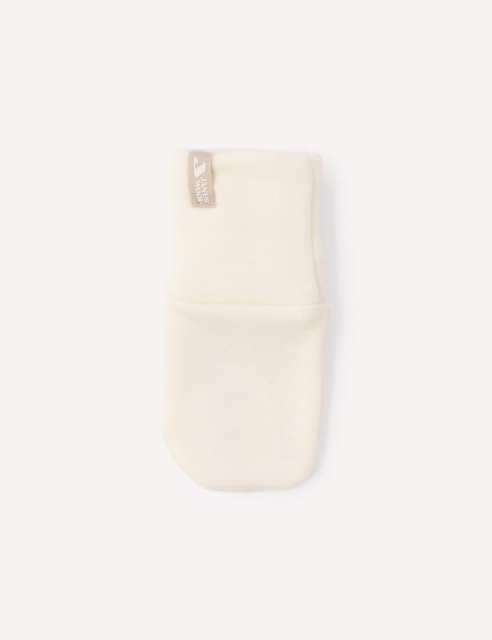 A single Mittens – Merino Baby AirWool in cream, crafted from soft merino wool with a beige tag, is displayed on a plain white background.