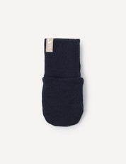 A single navy blue Mittens – Merino Baby AirWool is displayed against a plain light background, featuring a small beige fabric tag sewn near the wrist.