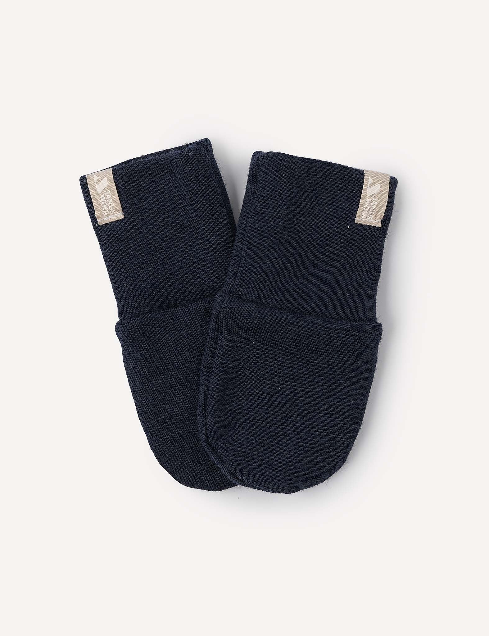 A pair of navy Merino Baby AirWool mittens featuring warm knit material, folded cuffs, and beige fabric tags attached to the top edges, displayed against a light background.