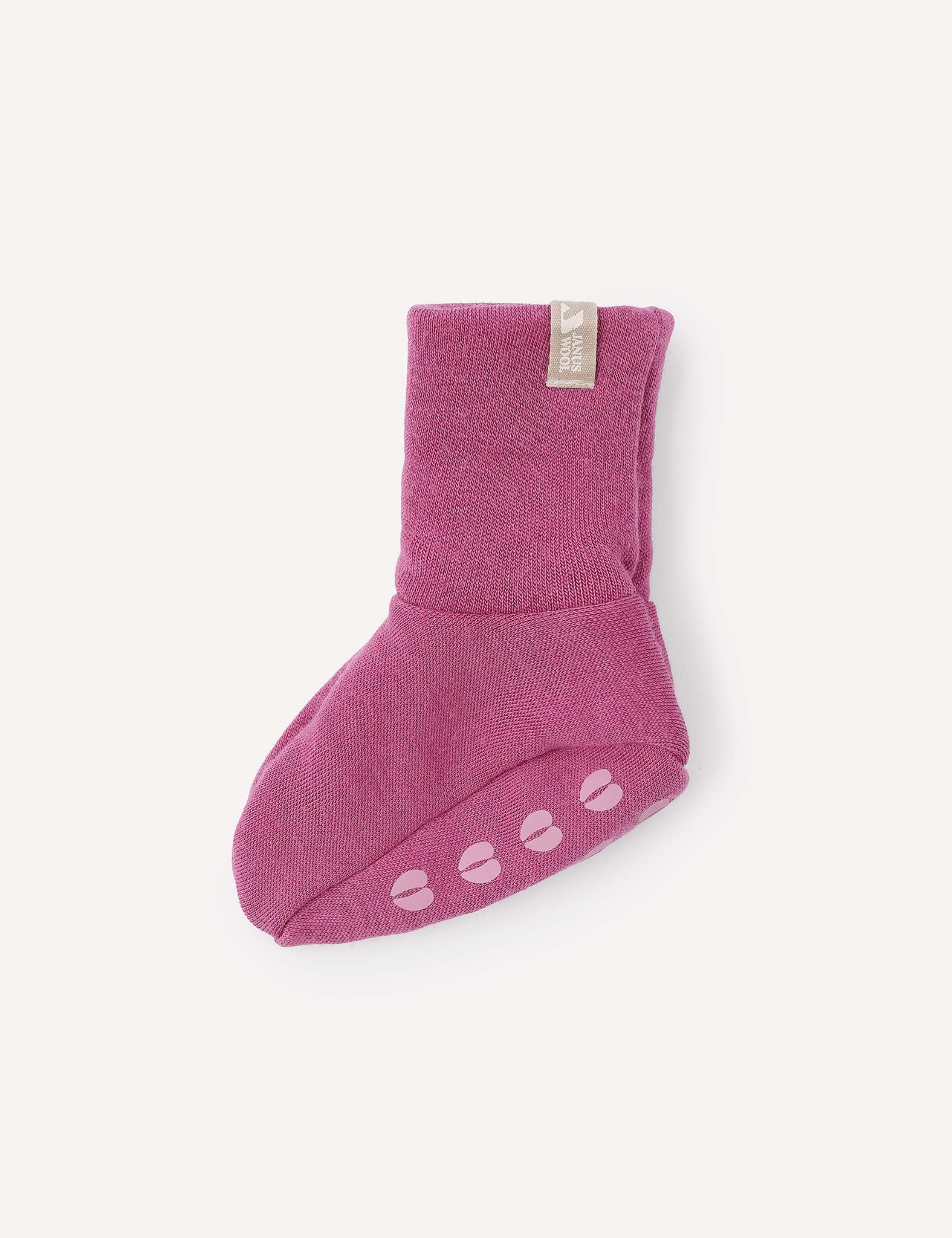A single pink Merino Baby AirWool bootie with non-slip grips on the sole, displayed on a plain light background.