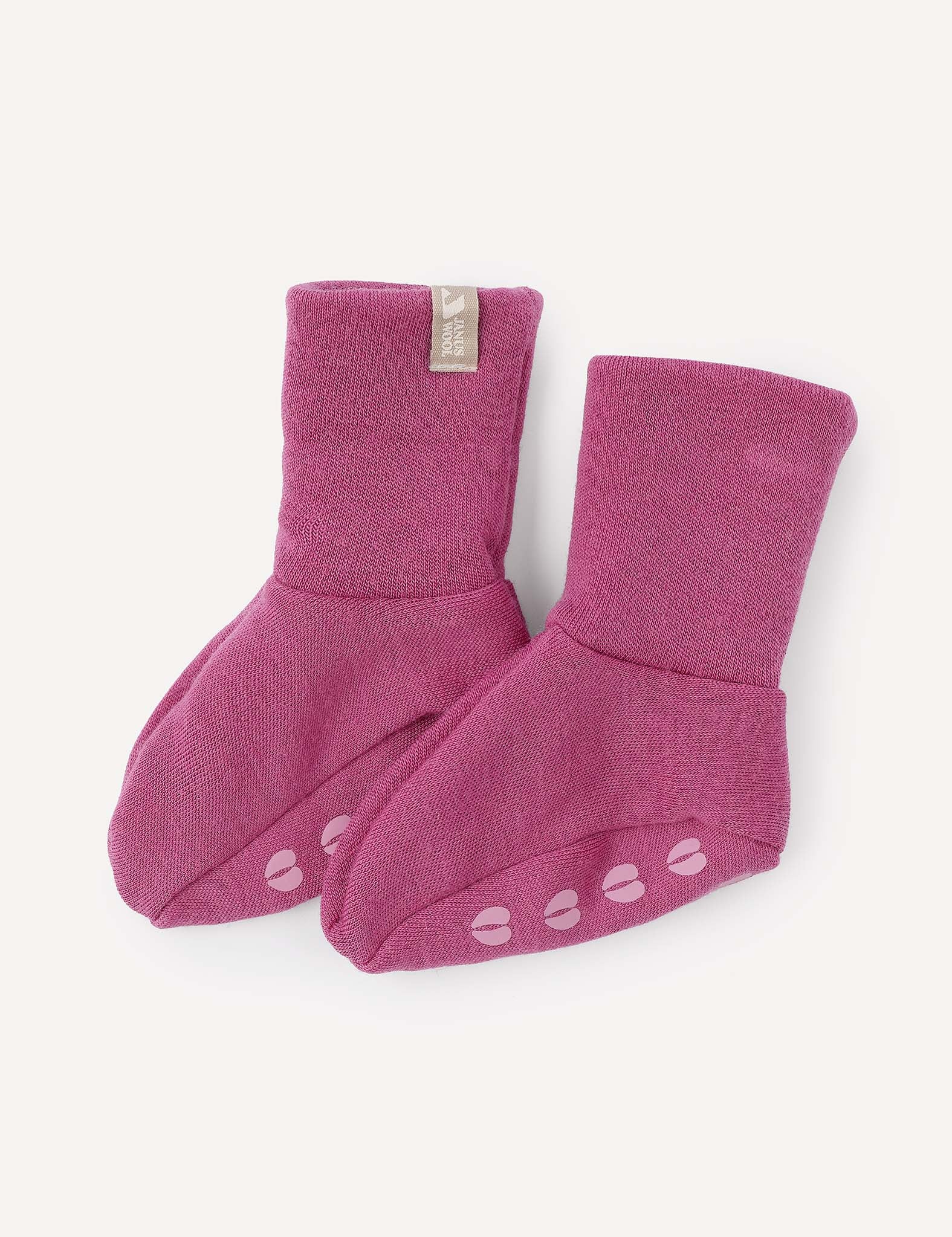 Two pink Booties – Merino Baby AirWool with non-slip grips on the soles, shown on a plain light background.
