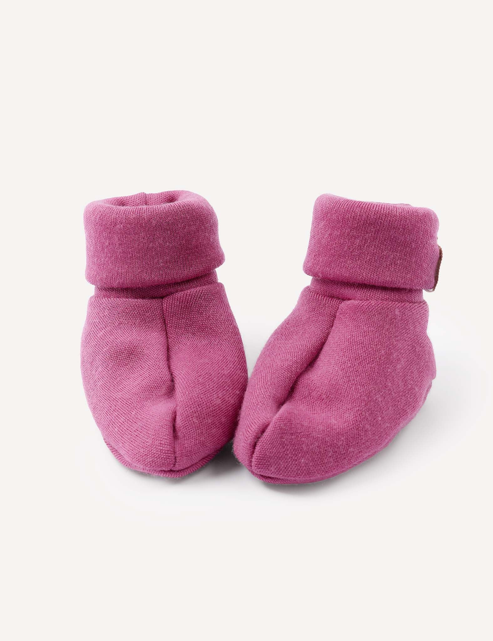 A pair of Booties – Merino Baby AirWool in Hawthorn Rose, featuring soft merino wool and folded cuffs, placed side by side on a light background.