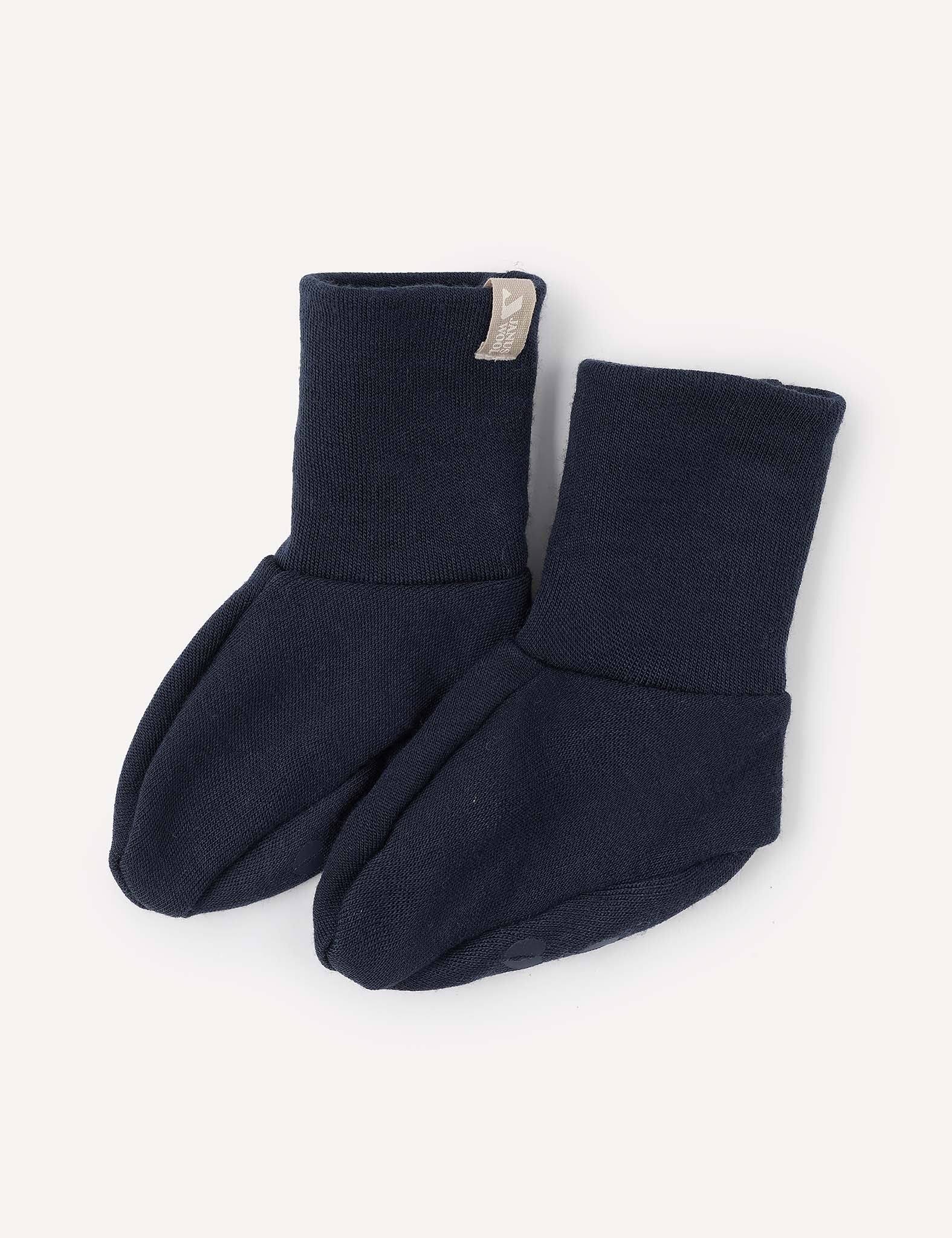 A pair of Booties – Merino Baby AirWool in navy blue, crafted from soft, stretchy fabric with folded cuffs, displayed on a light background.