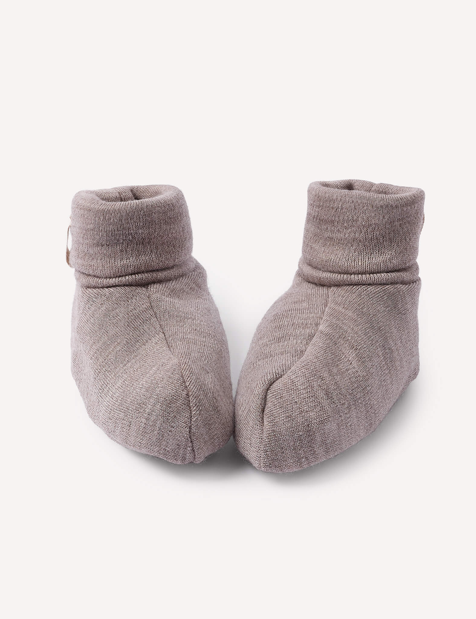 A pair of Booties – Merino Baby AirWool in Beige Melange are placed side by side on a plain white background.