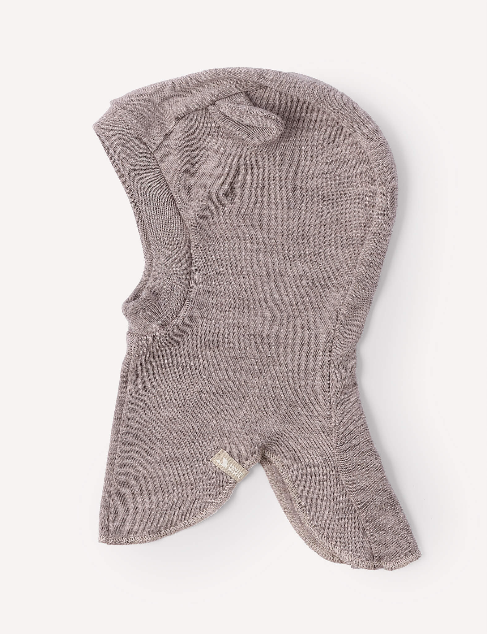 The Balaclava – Merino Baby AirWool is a soft, light brown merino wool headwear with a rounded hood and flared edges, designed for breathability and shown laid flat against a plain white background.