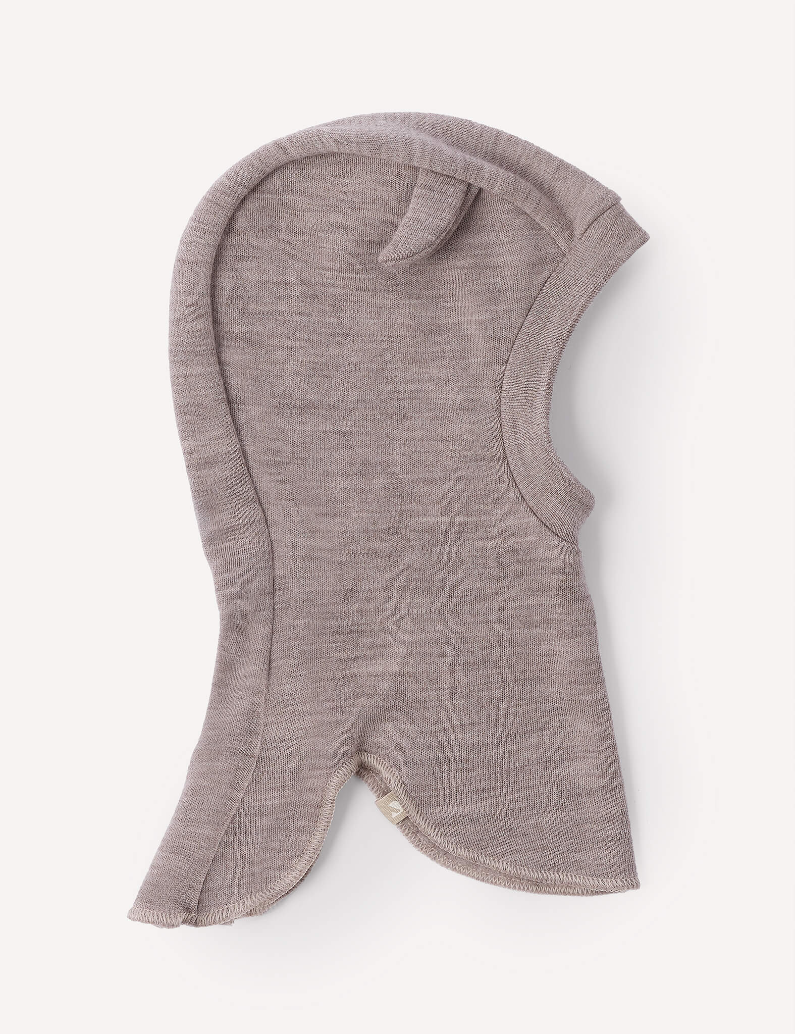 The Balaclava – Merino Baby AirWool in Beige Melange is a soft, knit merino wool balaclava for children, featuring a single ear-like detail on top and a face opening. This breathable headwear ensures lasting comfort and warmth throughout the day.