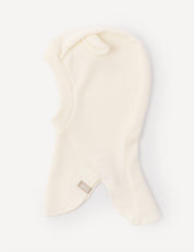 The Balaclava – Merino Baby AirWool is a cream-colored, fleece headwear featuring a small fabric tag at the front. Displayed on a plain white background, this breathable balaclava provides added comfort with its AirWool insulation.
