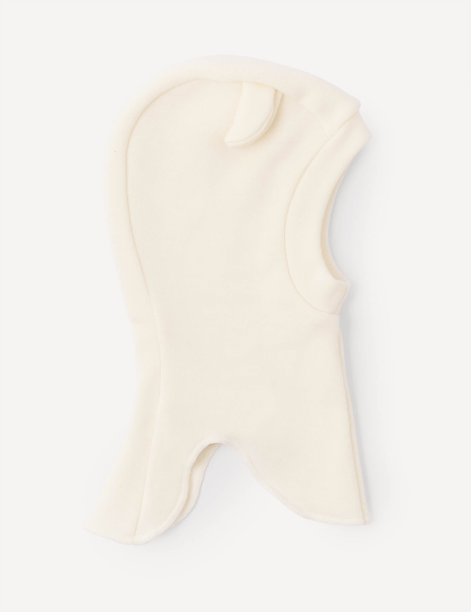 A marshmallow-colored Balaclava – Merino Baby AirWool for children, made from soft fleece merino wool, featuring a small ear-shaped detail on top and an opening for the face and neck.