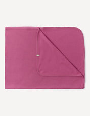 A folded Blanket – Merino Baby AirWool in Hawthorn Rose with rounded edges, displaying both the front and back sides, lying flat on a white background.