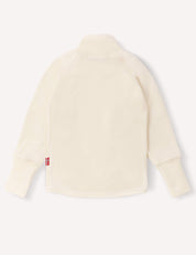 Back view of the Jacket – Merino Baby AirWool, a long-sleeve zip jacket in a cream color with a mock neck and red tag detail on the left side seam. The soft, cozy fabric provides breathable insulation, making it ideal for cool weather.