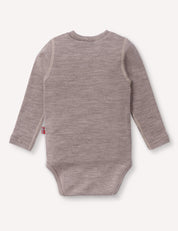 A long-sleeve, light brown Body – Merino Baby AirWool onesie is shown from the back against a plain white background. A small fabric tag with a striped design is visible on the left side seam, emphasizing its breathable comfort.