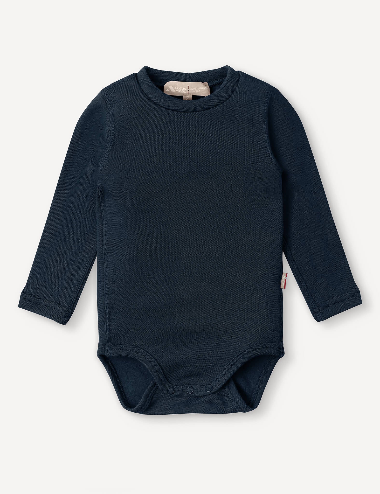 The Body – Merino Baby AirWool in navy is a long-sleeve merino wool bodysuit featuring snap buttons at the bottom for easy changing and offering breathable insulation, shown against a white background.